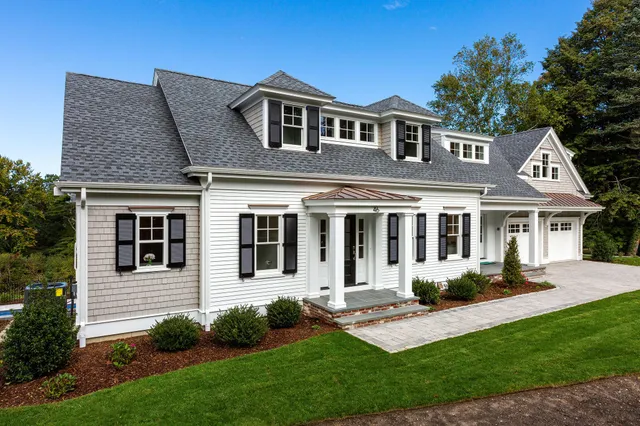 a view of a house with a yard and sitting area