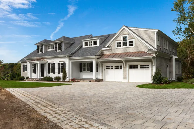 a view of a house with a yard and large windows