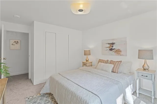 a bedroom with a bed and a painting on the wall