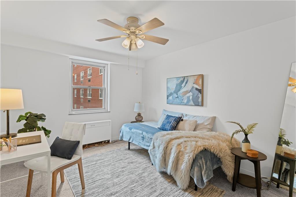 4601 Fifth Avenue, Unit 327 Pittsburgh, PA 15213 - Photo 15 of 25 a bedroom with a bed and a chandelier