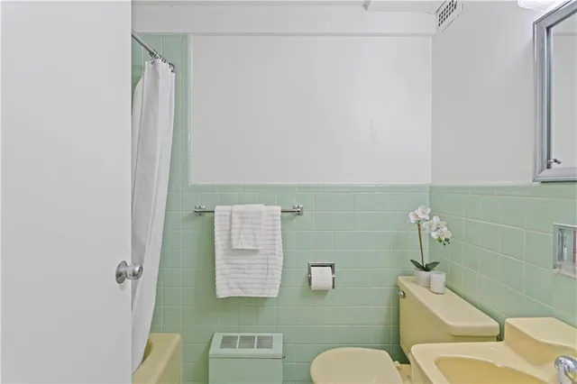 a bathroom with a sink toilet and mirror
