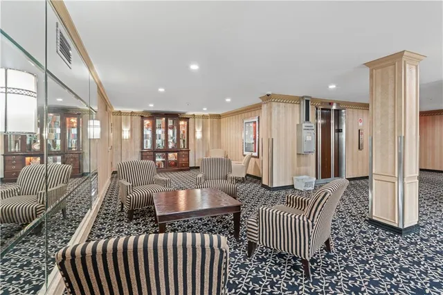 a room with a couch and potted plant