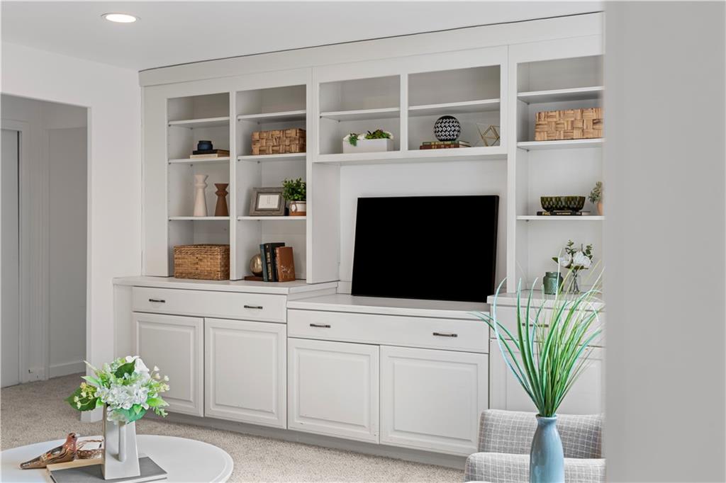 4601 Fifth Avenue, Unit 327 Pittsburgh, PA 15213 - Photo 4 of 25 a living room with a fireplace and a potted plant