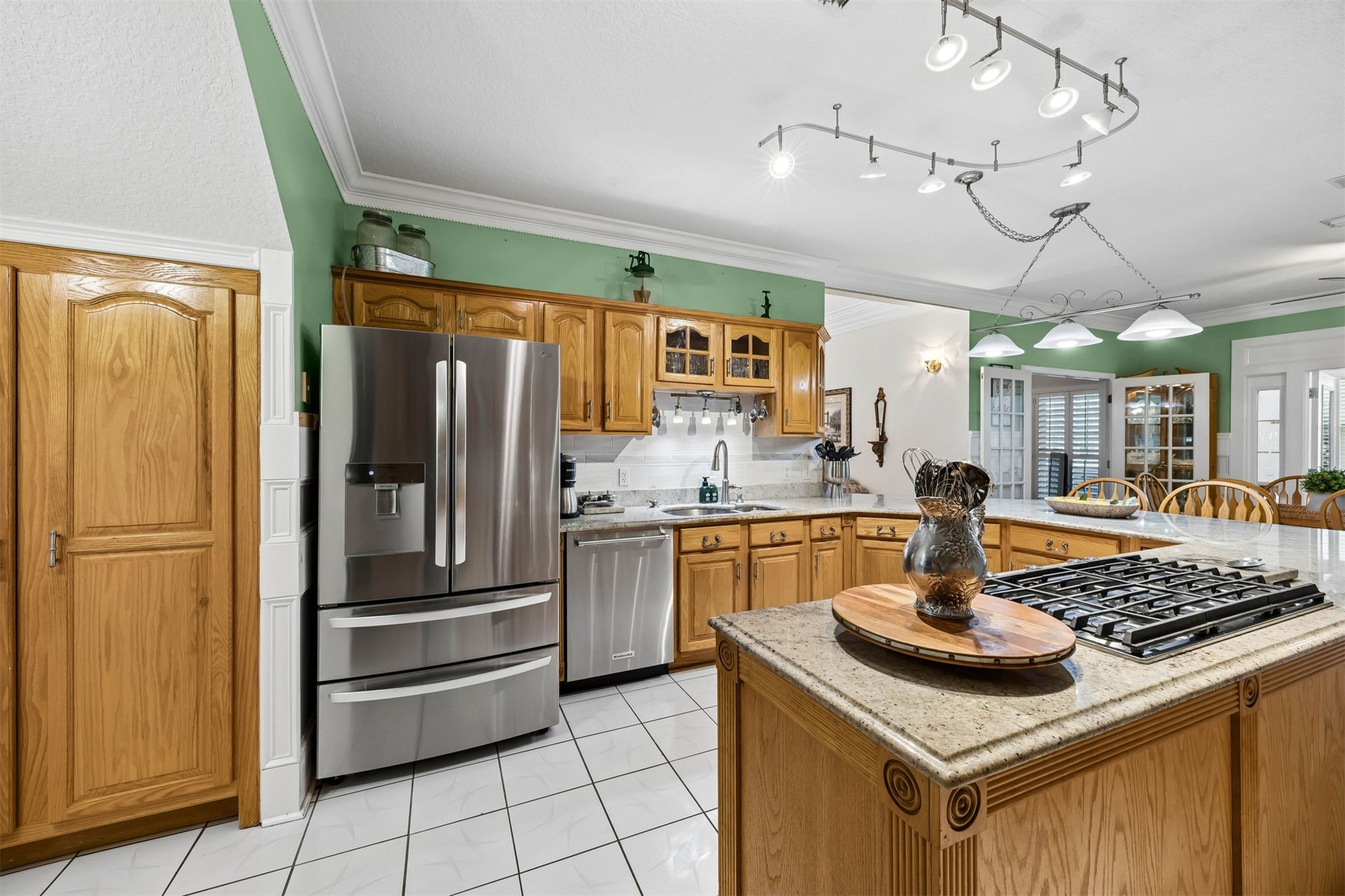 376488 Kings Ferry Road Hilliard, FL 32046 - Photo 22 of 73 a kitchen with stainless steel appliances granite countertop a sink and a refrigerator