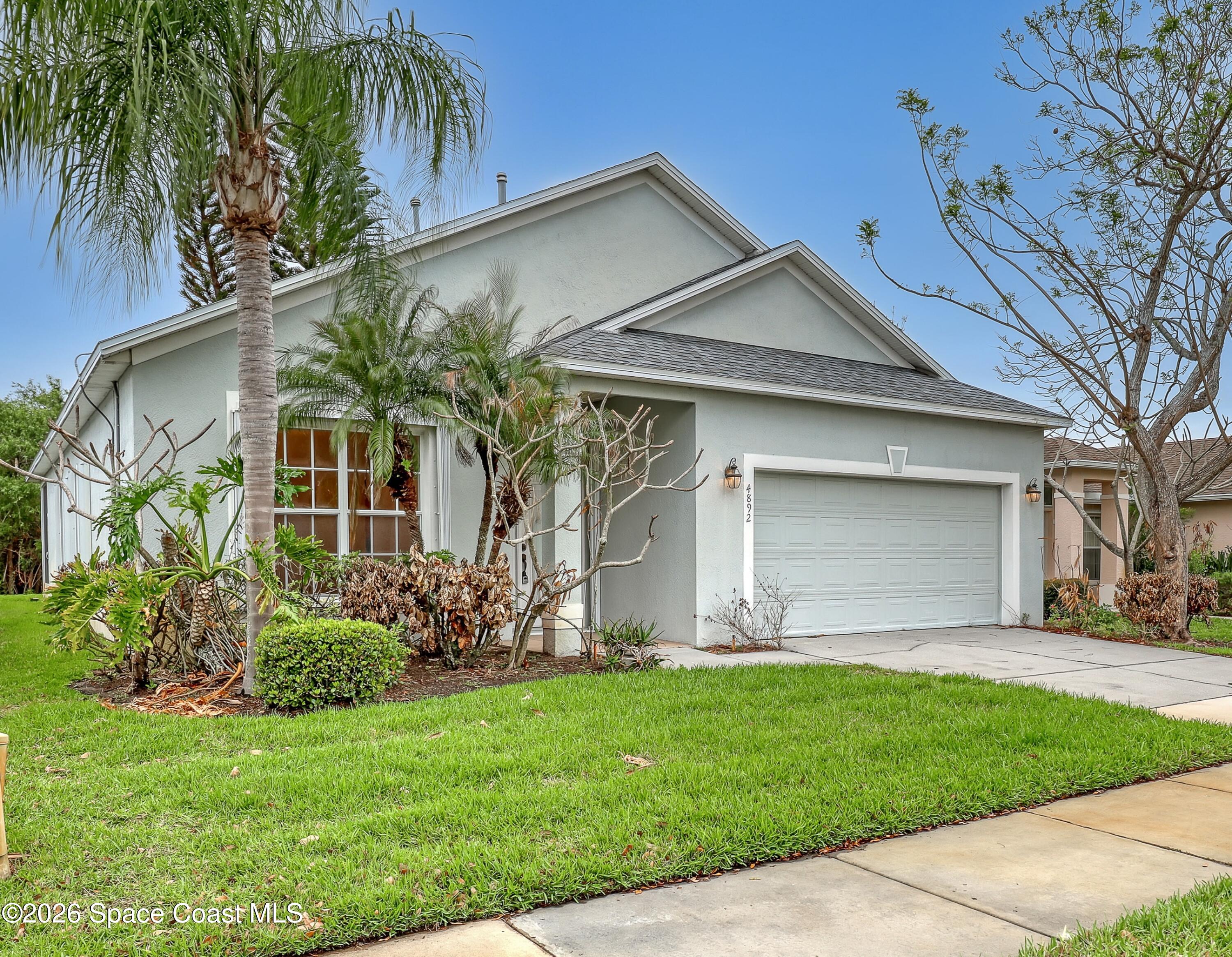 4892 Outlook Drive Melbourne, FL 32940 - Photo 1 of 34 a view of a house with a yard