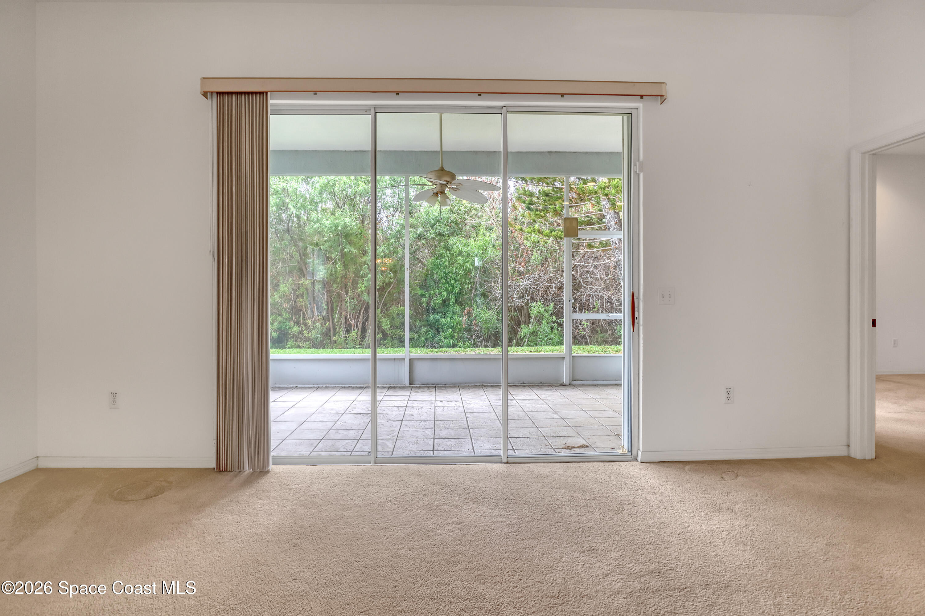 4892 Outlook Drive Melbourne, FL 32940 - Photo 11 of 34 a view of an empty room with sliding glass door