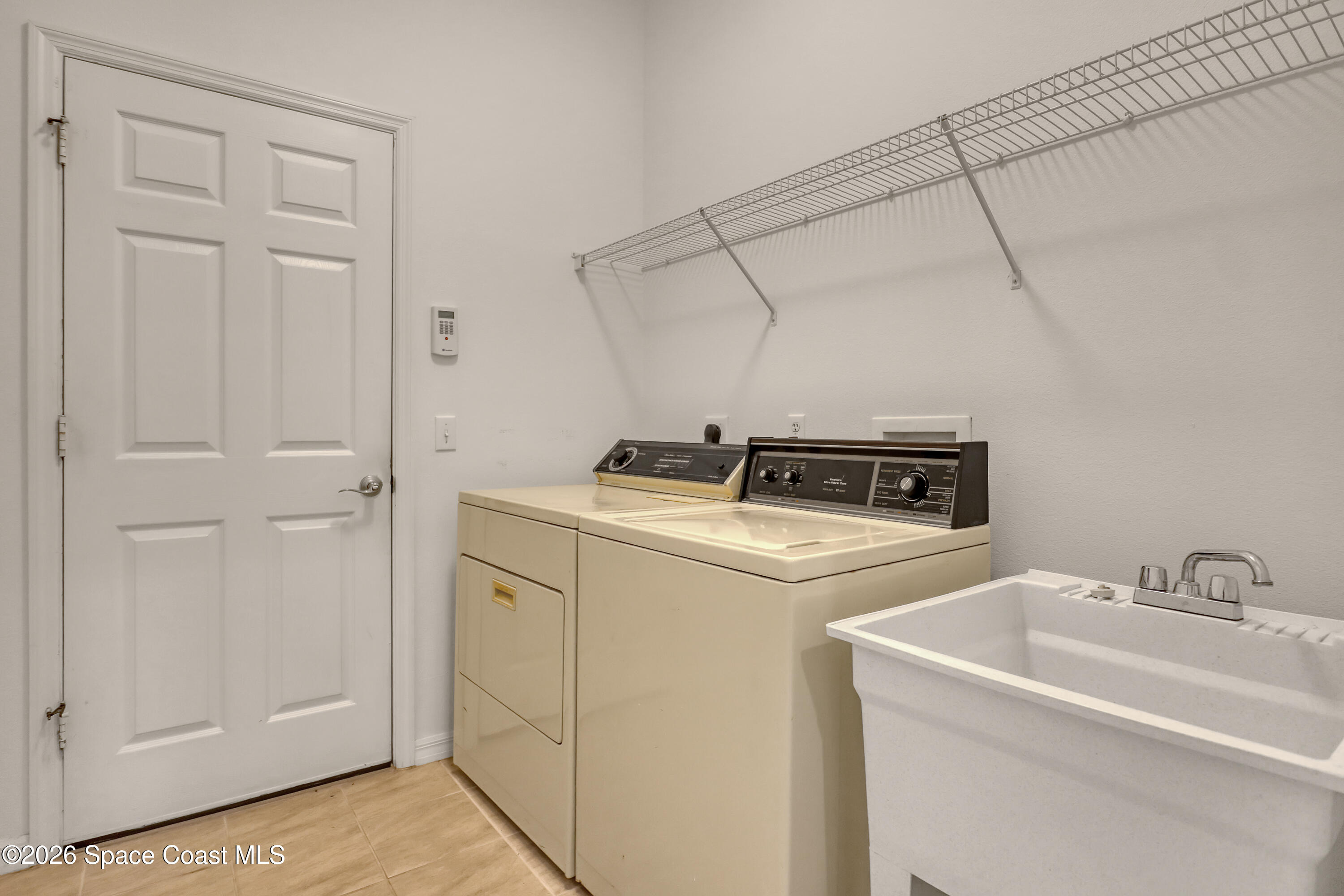 4892 Outlook Drive Melbourne, FL 32940 - Photo 29 of 34 a utility room with dryer and washer