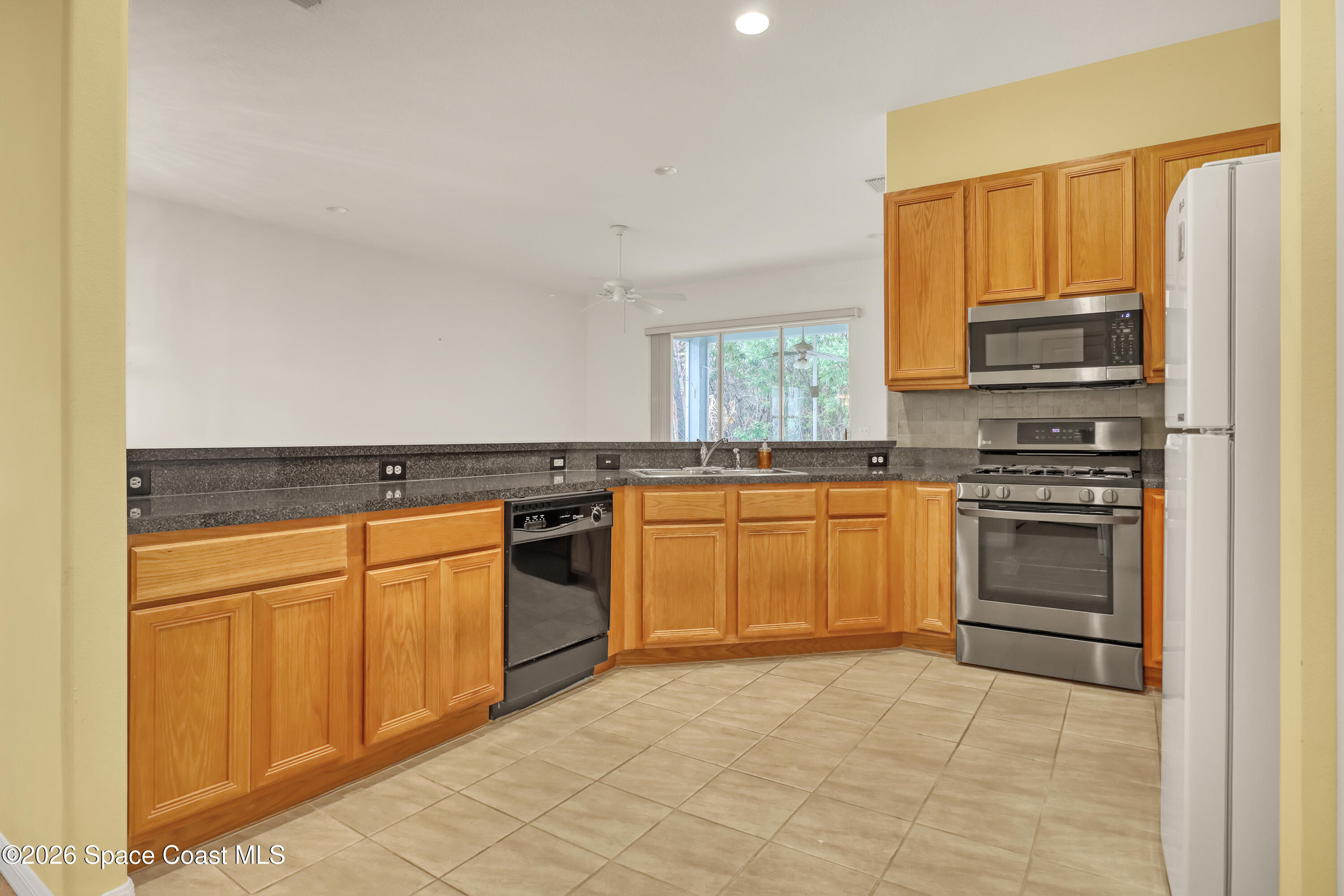 4892 Outlook Drive Melbourne, FL 32940 - Photo 3 of 34 a kitchen with granite countertop stainless steel appliances and cabinets