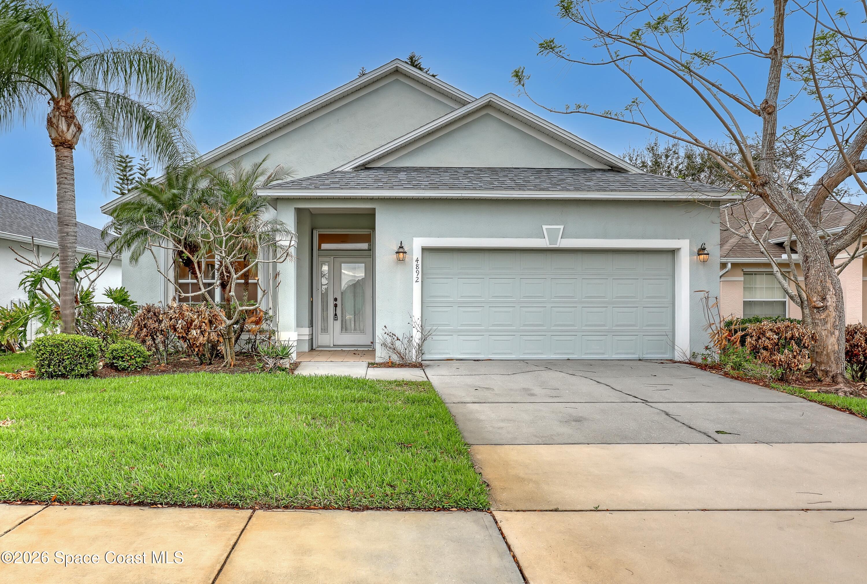 4892 Outlook Drive Melbourne, FL 32940 - Photo 33 of 34 a front view of a house with a garden