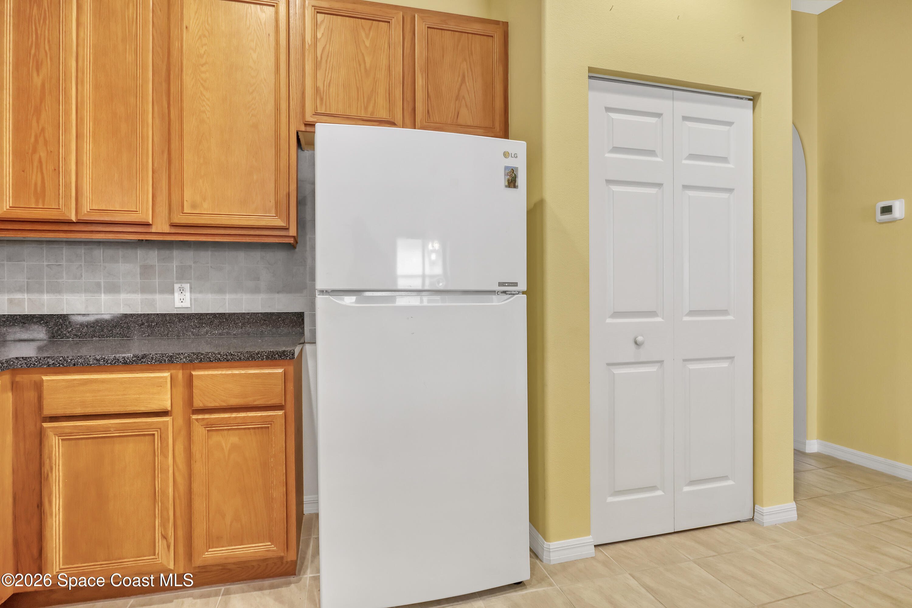 4892 Outlook Drive Melbourne, FL 32940 - Photo 6 of 34 a white refrigerator freezer sitting in a kitchen