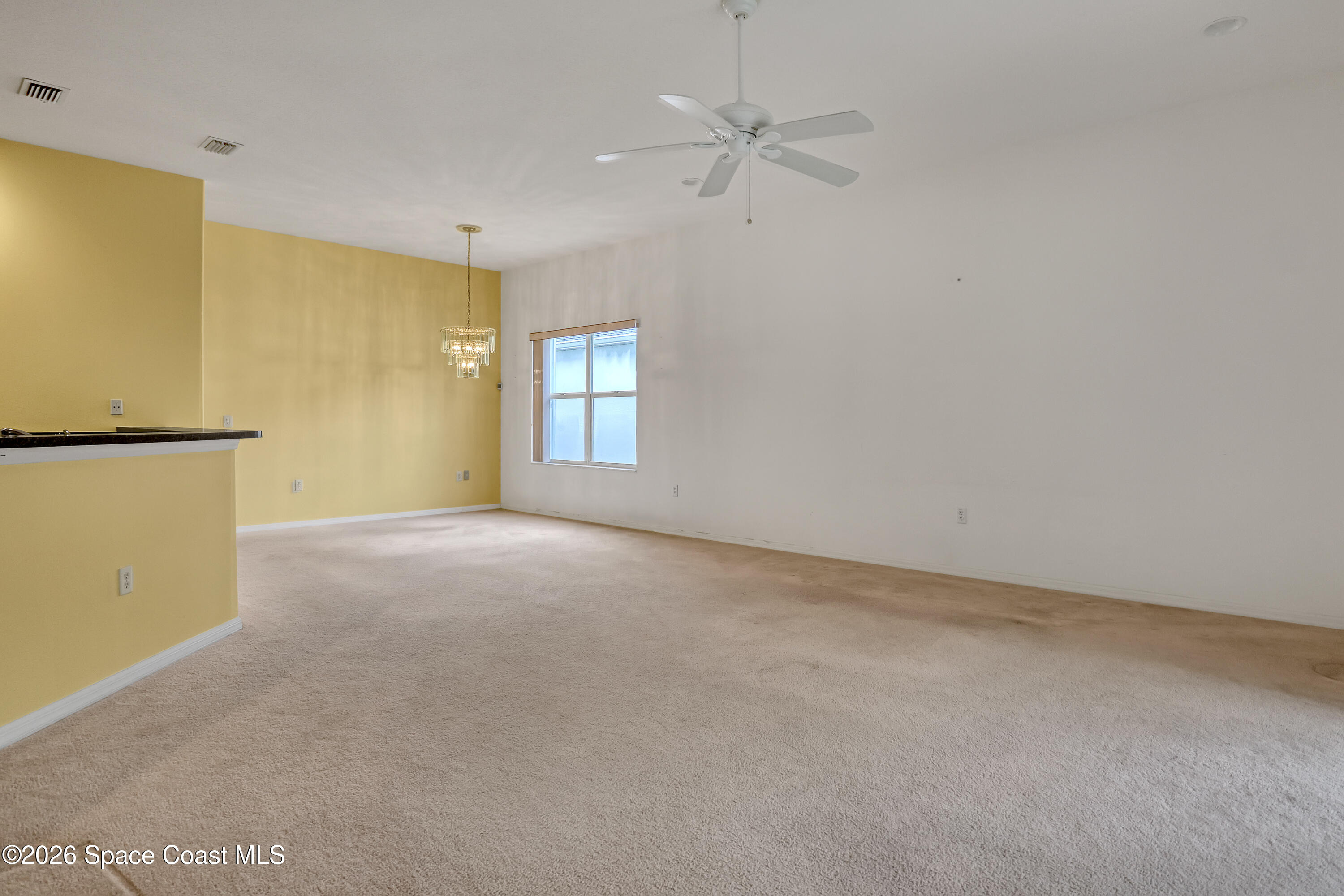 4892 Outlook Drive Melbourne, FL 32940 - Photo 9 of 34 an empty room with windows and fan