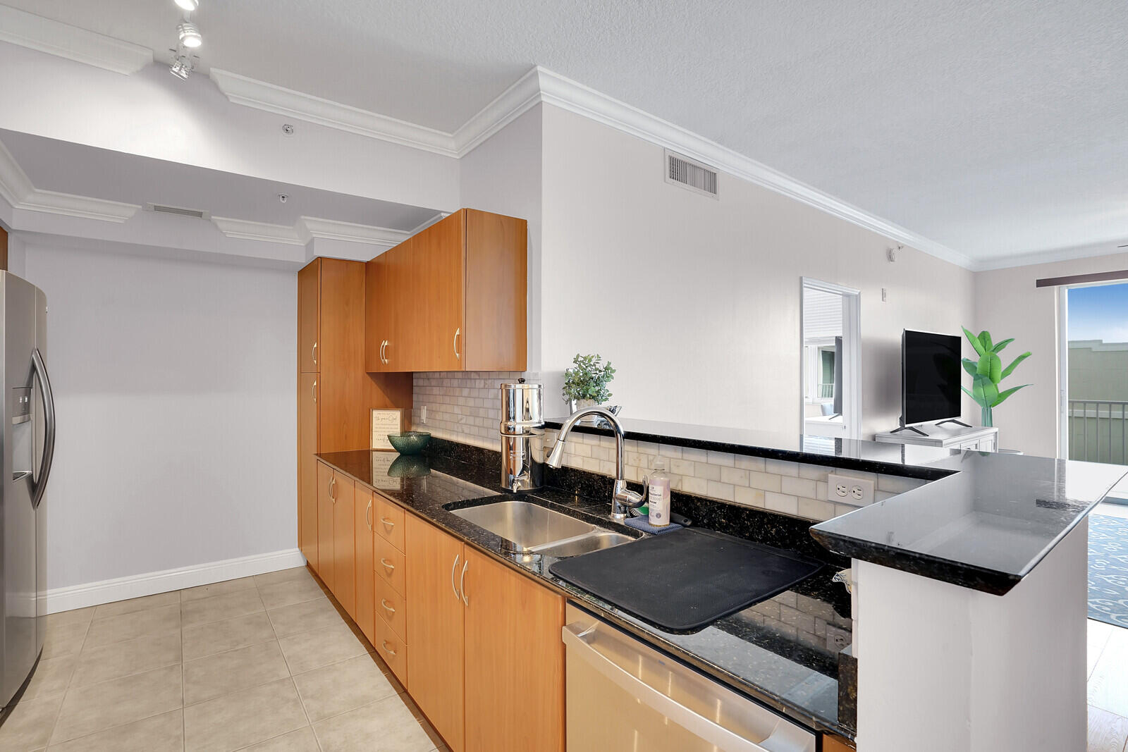 804 East Windward Way, Unit 608 Lantana, FL 33462 - Photo 12 of 33 a kitchen with granite countertop a sink and a stove top oven