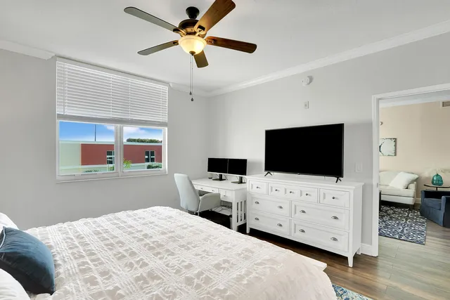 a bedroom with a bed and a flat screen tv