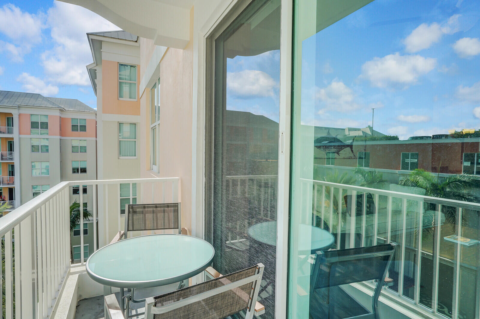 804 East Windward Way, Unit 608 Lantana, FL 33462 - Photo 23 of 33 a view of a balcony with chair and glass door