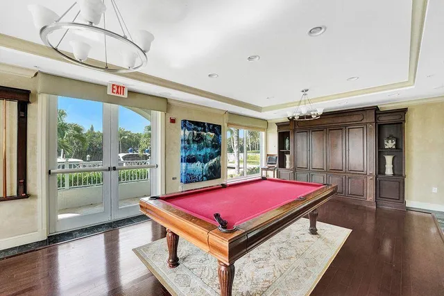 a room with pool table and wooden floor