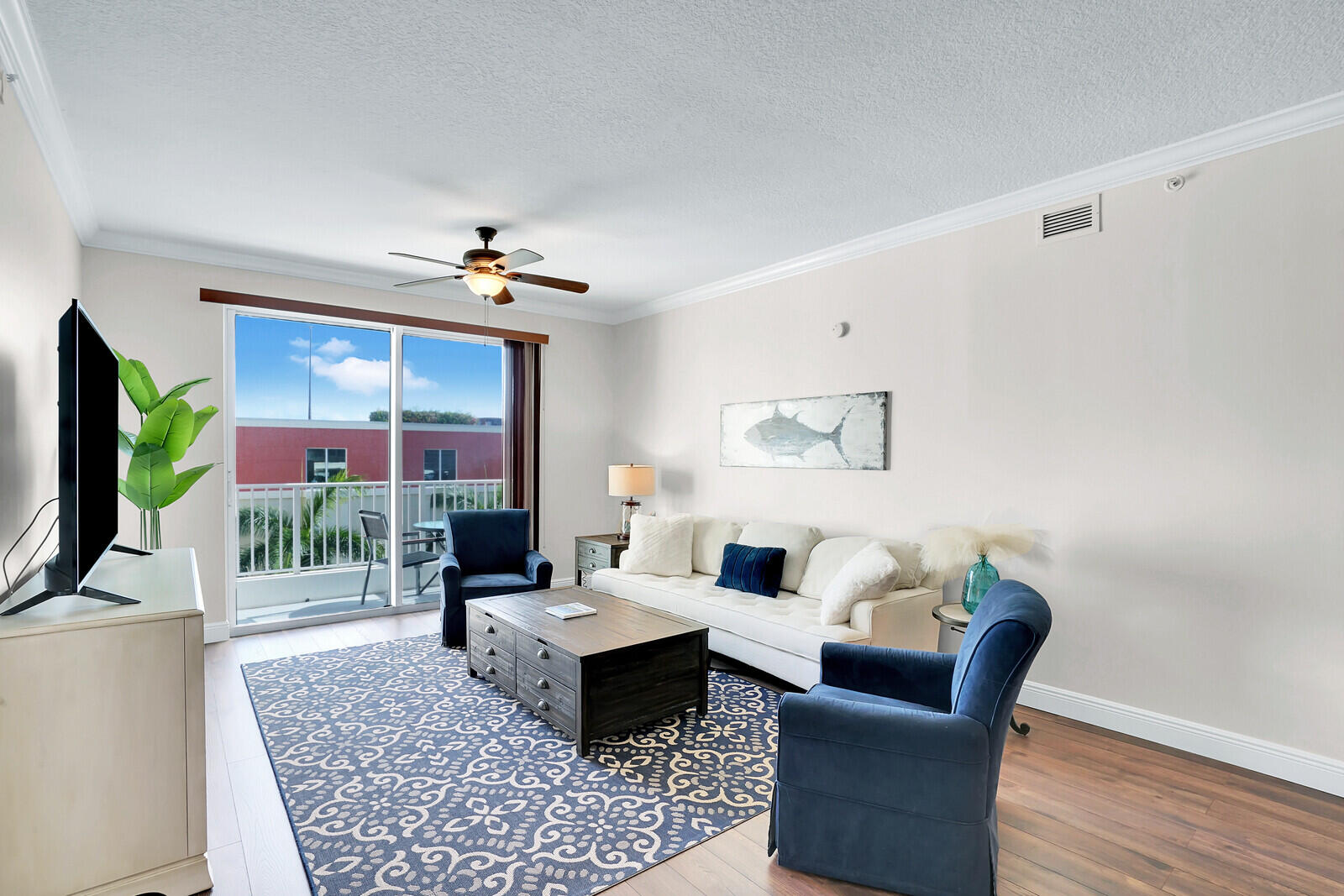 804 East Windward Way, Unit 608 Lantana, FL 33462 - Photo 3 of 33 a living room with furniture a rug and a flat screen tv