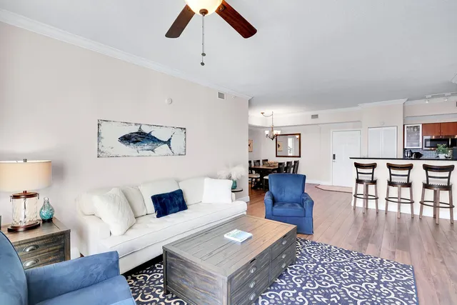 a living room with furniture and a wooden floor