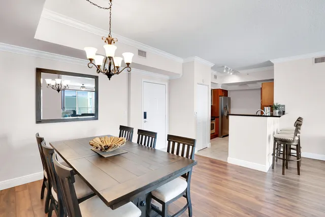 a view of a dining room with furniture wooden floor and chandelier