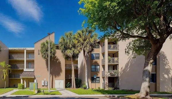 a view of a building with a tree in front of it
