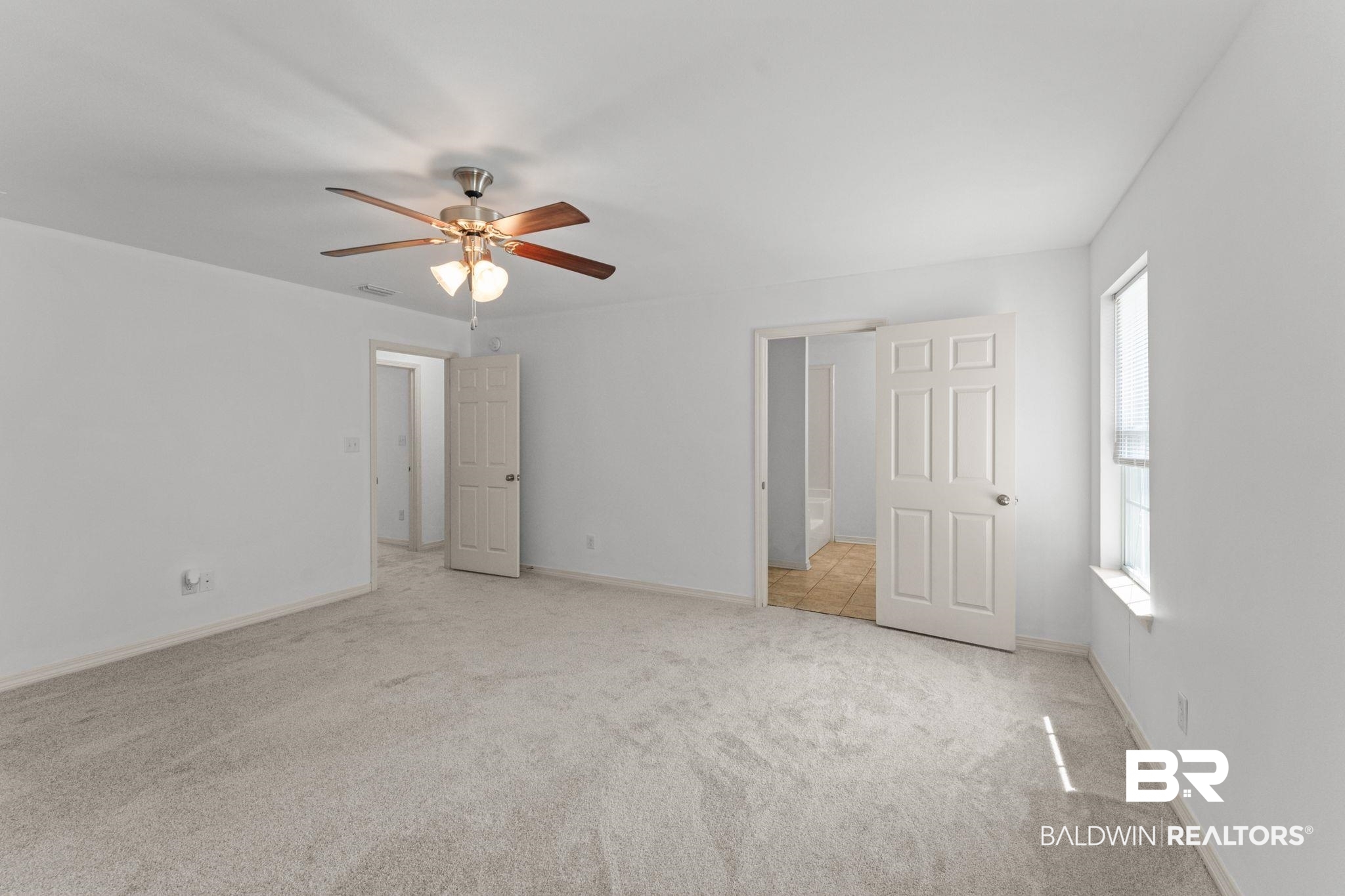 10535 Rhett McConnell Road Theodore, AL 36582 - Photo 18 of 36 Unfurnished bedroom with light colored carpet and a ceiling fan