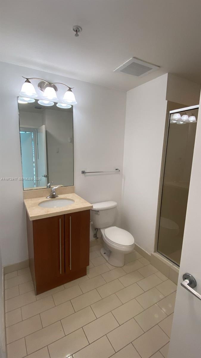 1111 Southwest 1st Avenue, Unit 2016N Miami, FL 33130 - Photo 15 of 20 a bathroom with a sink vanity mirror and toilet