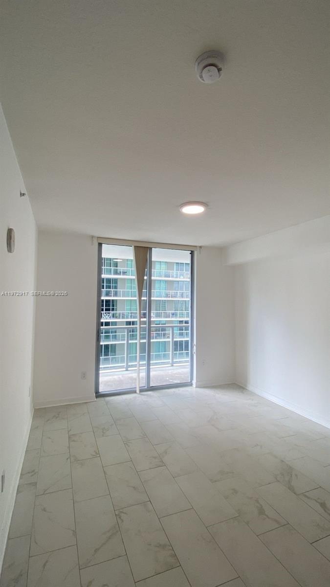 1111 Southwest 1st Avenue, Unit 2016N Miami, FL 33130 - Photo 16 of 20 a view of an empty room with a window