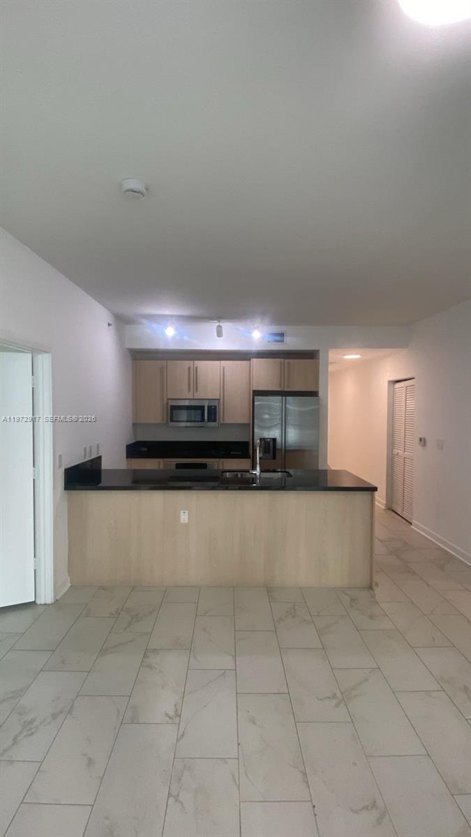 1111 Southwest 1st Avenue, Unit 2016N Miami, FL 33130 - Photo 2 of 20 a large white kitchen with a stove a sink a microwave and a refrigerator