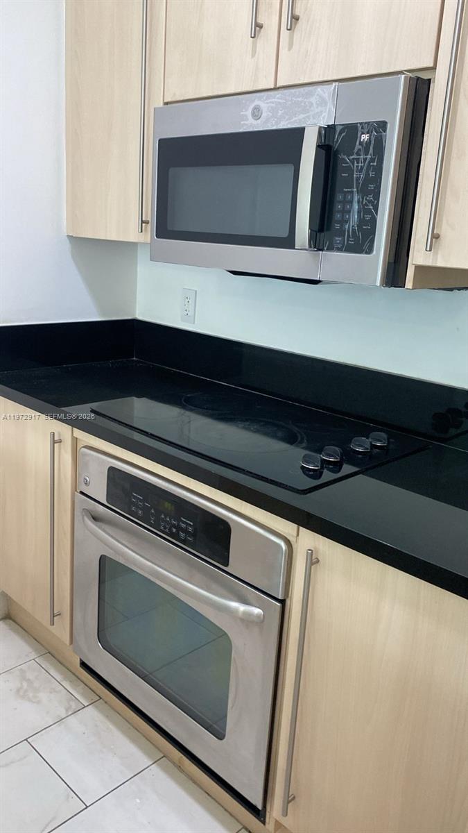 1111 Southwest 1st Avenue, Unit 2016N Miami, FL 33130 - Photo 4 of 20 a kitchen with a stove microwave and sink