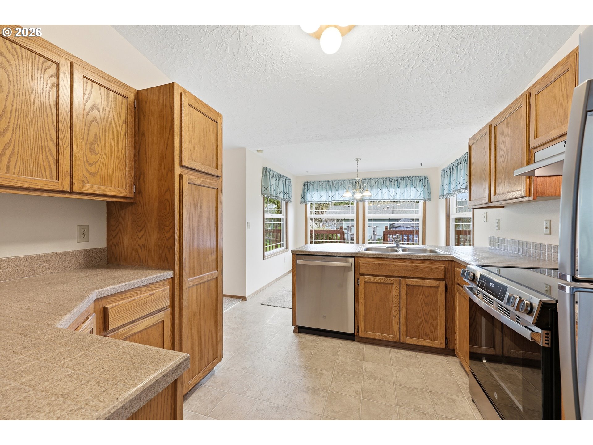 419 Southwest Day Court Gresham, OR 97080 - Photo 13 of 44 a kitchen with granite countertop a refrigerator stove top oven and sink