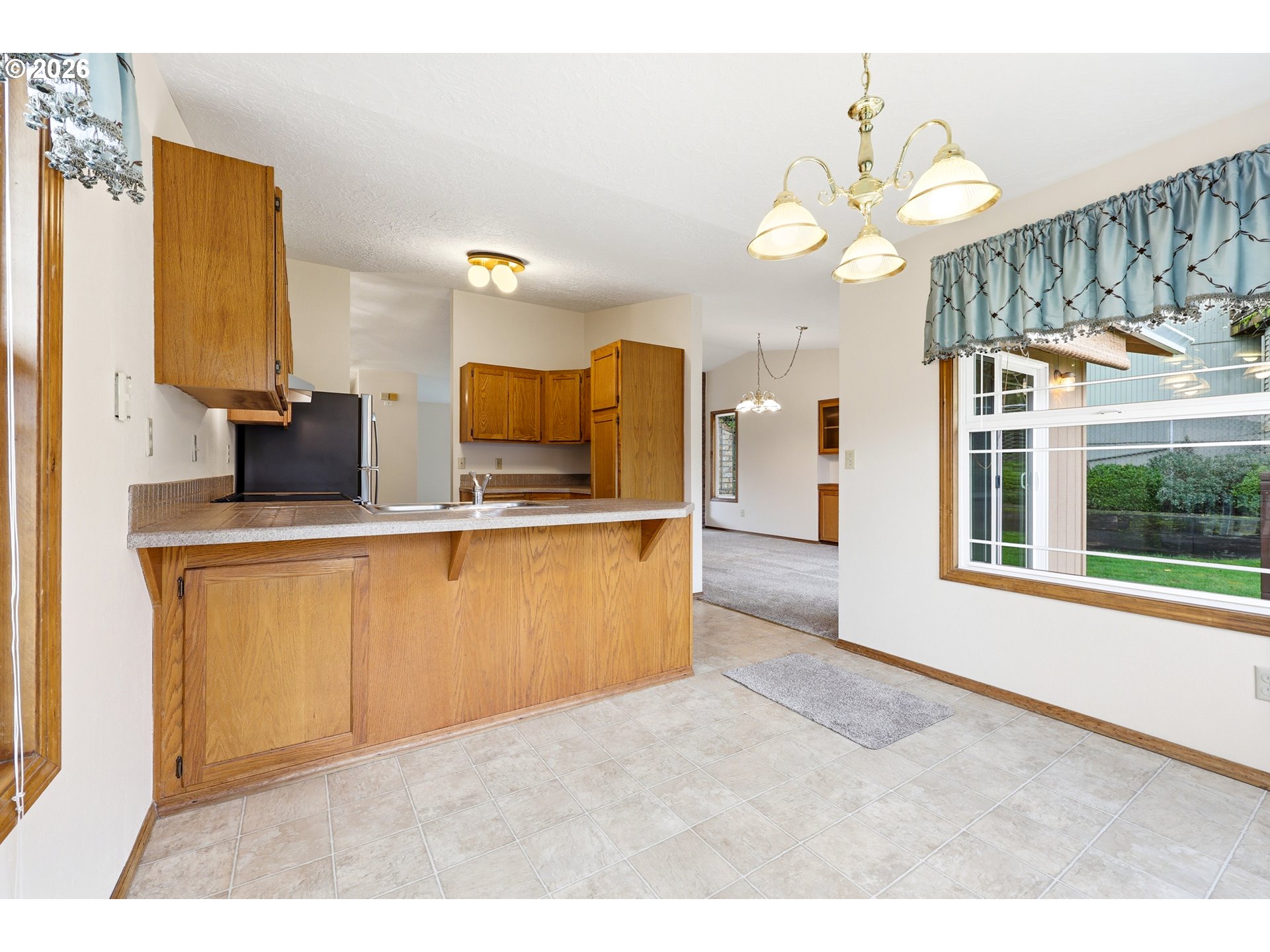 419 Southwest Day Court Gresham, OR 97080 - Photo 14 of 44 a kitchen view with granite countertop a sink cabinets and stainless steel appliances