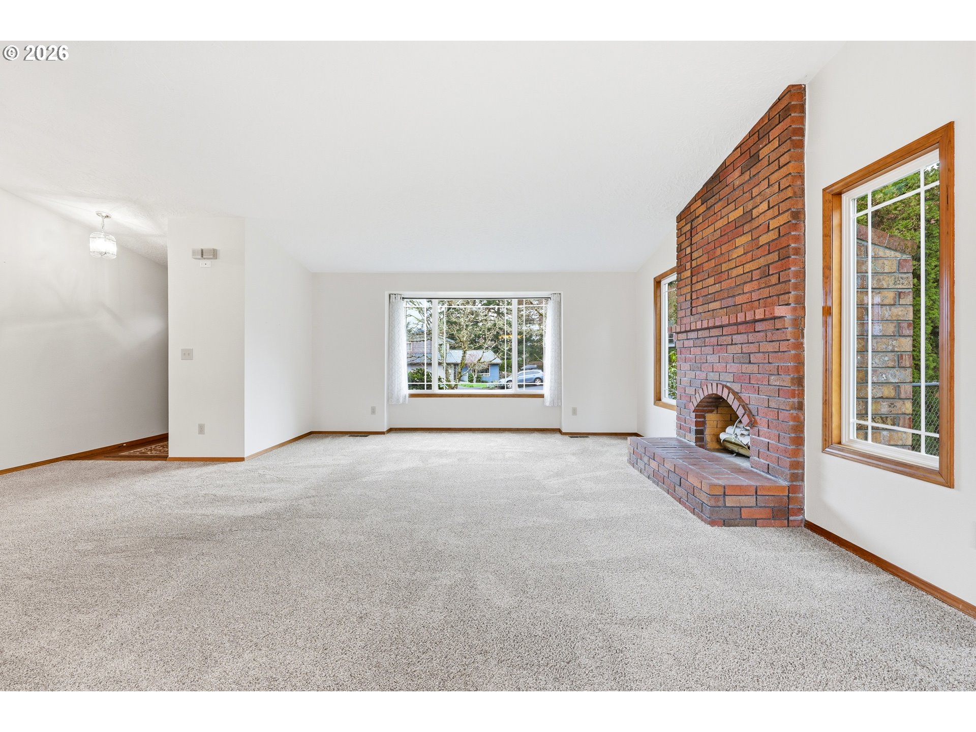 419 Southwest Day Court Gresham, OR 97080 - Photo 18 of 44 a view of an empty room with a fireplace and windows