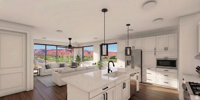 271 North Country Lane, Unit 60 St. George, UT 84770 - Photo 16 of 17 Kitchen featuring dark wood-style flooring, light stone counters, open floor plan, and a center island with sink