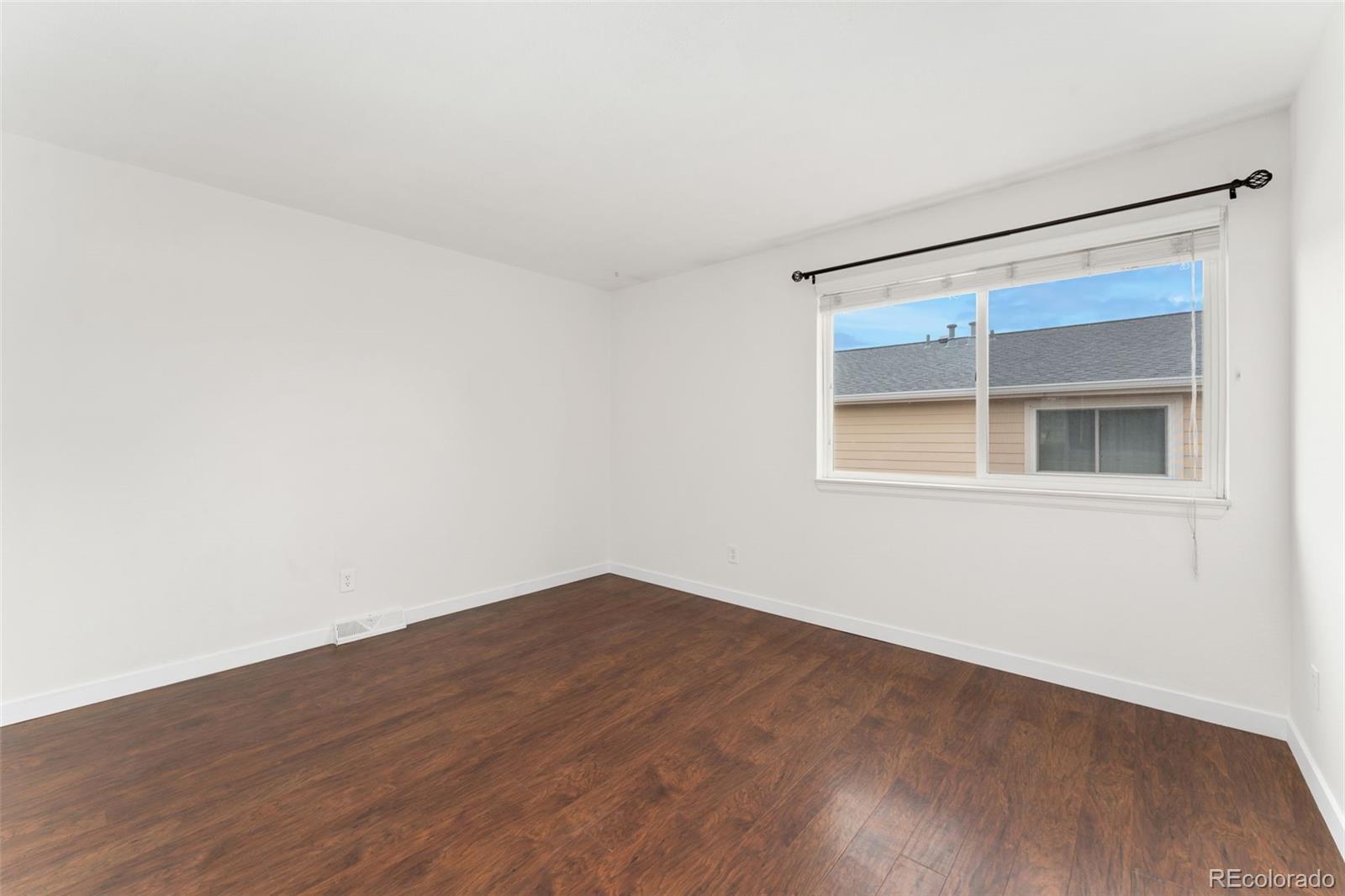 8919 Field Street, Unit 131 Broomfield, CO 80021 - Photo 11 of 27 a view of empty room with wooden floor and fan