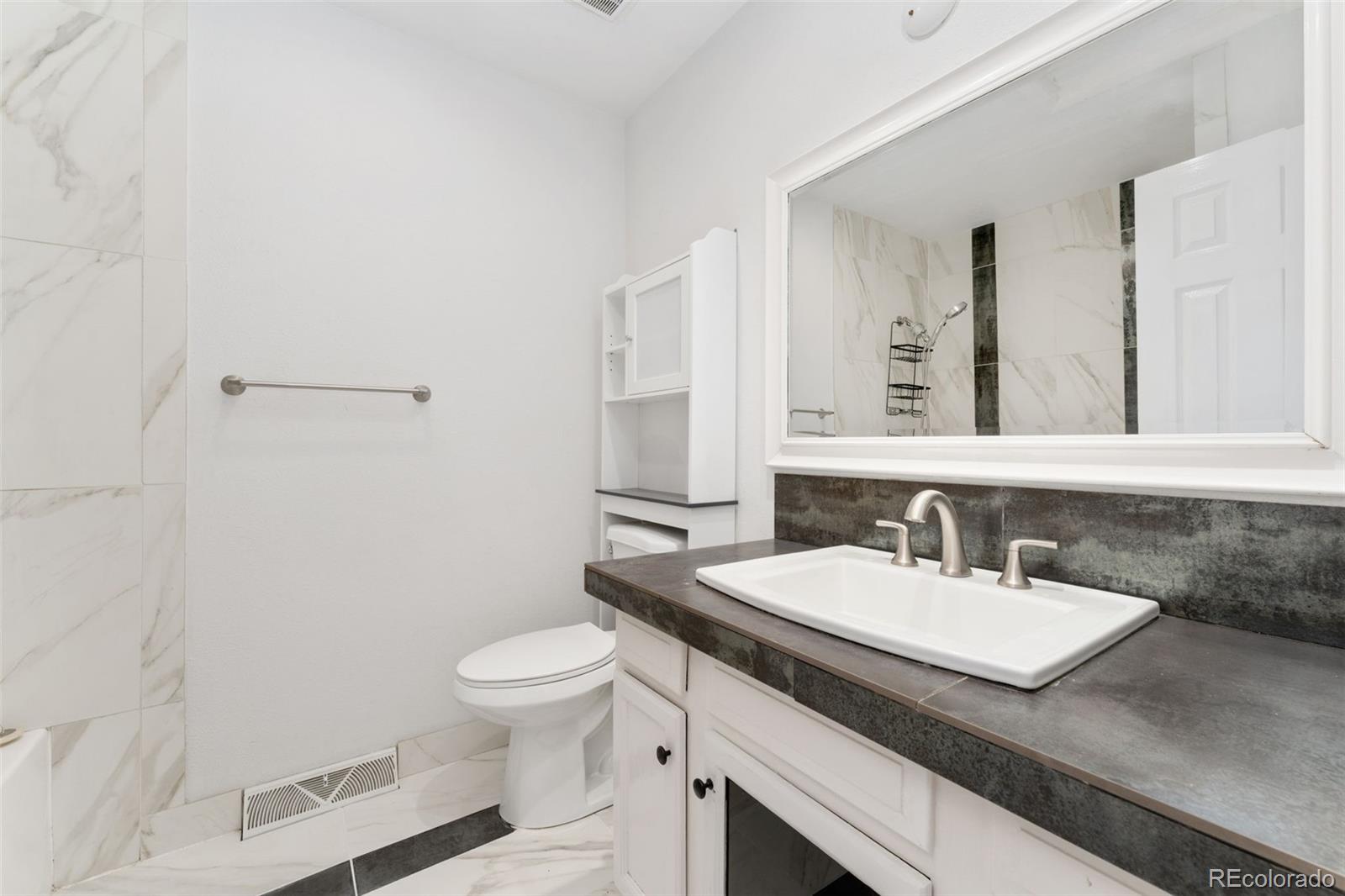 8919 Field Street, Unit 131 Broomfield, CO 80021 - Photo 13 of 27 a bathroom with a sink and a toilet