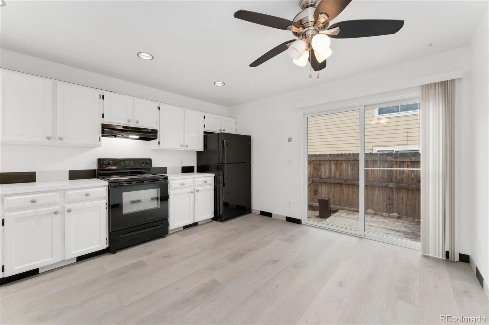 8919 Field Street, Unit 131 Broomfield, CO 80021 - Photo 6 of 27 a kitchen with a refrigerator a stove top oven a sink and cabinets
