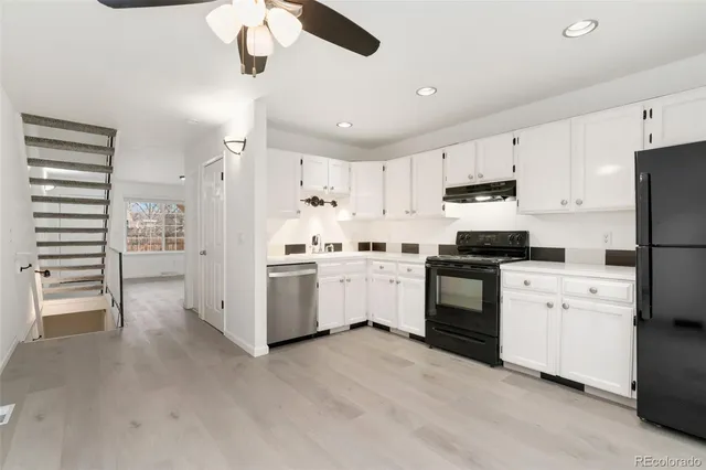 a kitchen with white cabinets and white appliances