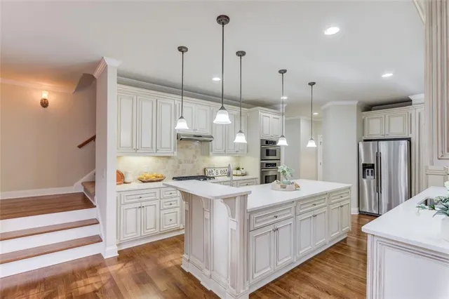 a view of kitchen cabinets and refrigerator