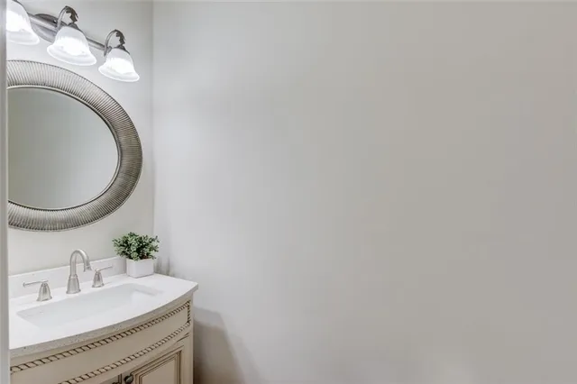 a view of a yard with plants and large trees