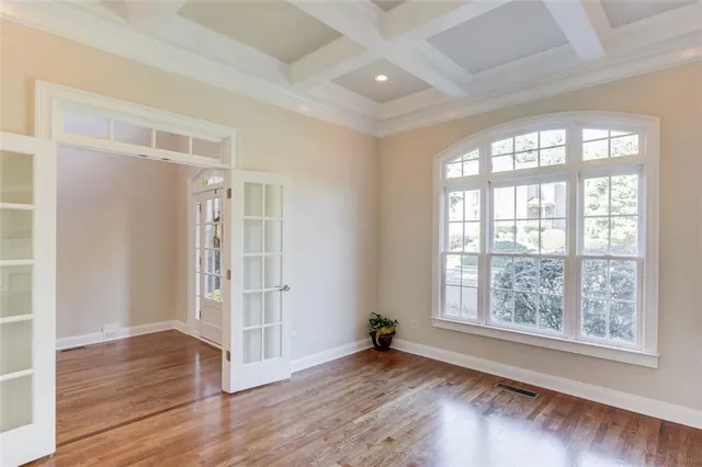 a kitchen with stainless steel appliances granite countertop white cabinets and window