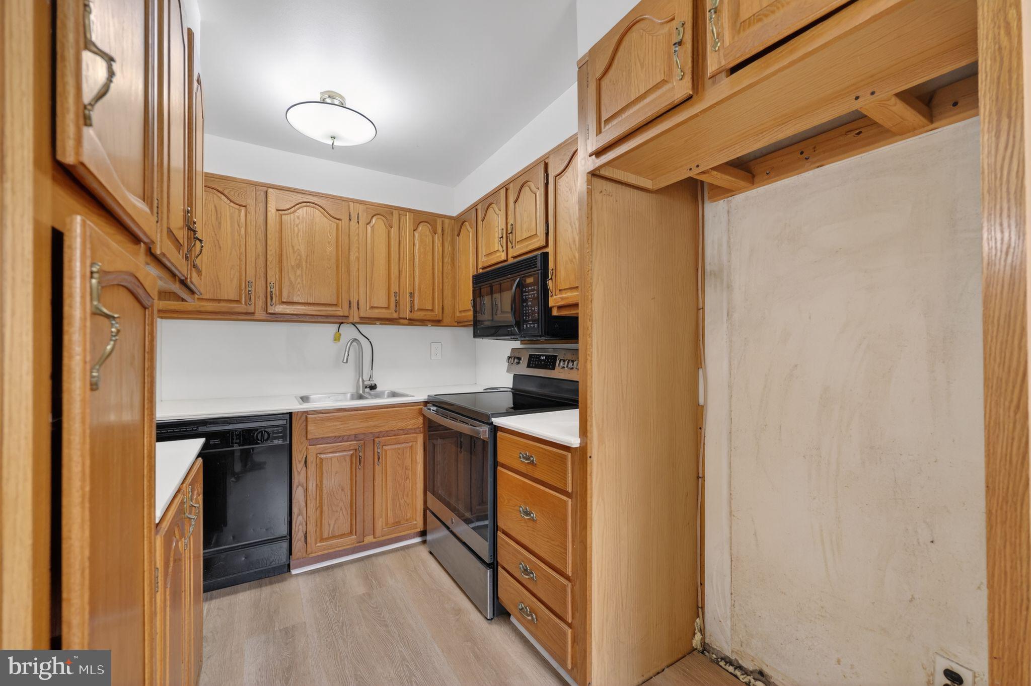 948 Grant Road Folcroft, PA 19032 - Photo 14 of 31 a kitchen with stainless steel appliances granite countertop a sink stove and refrigerator