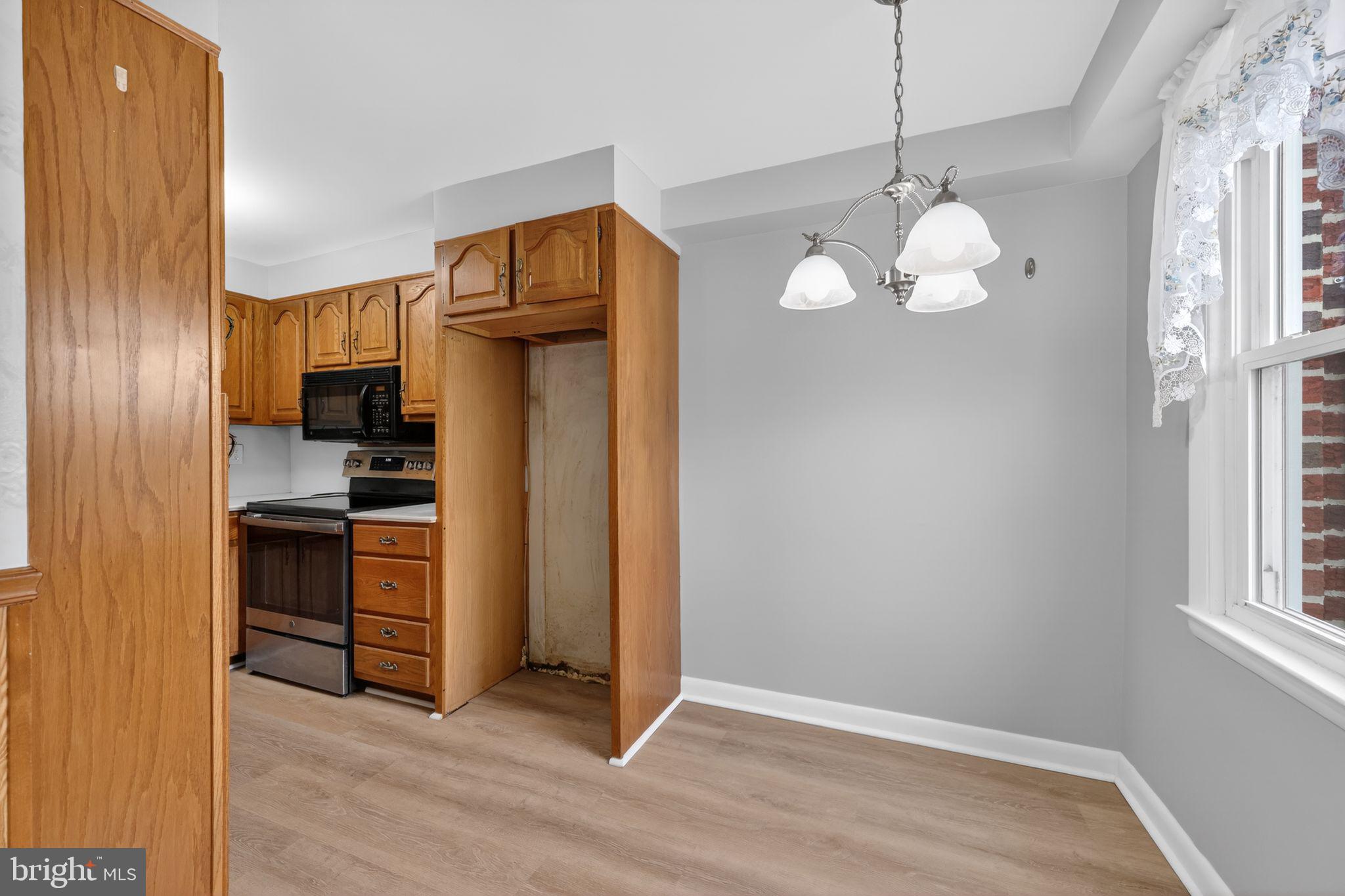 948 Grant Road Folcroft, PA 19032 - Photo 16 of 31 a kitchen with stainless steel appliances granite countertop a refrigerator a stove and a wooden floors