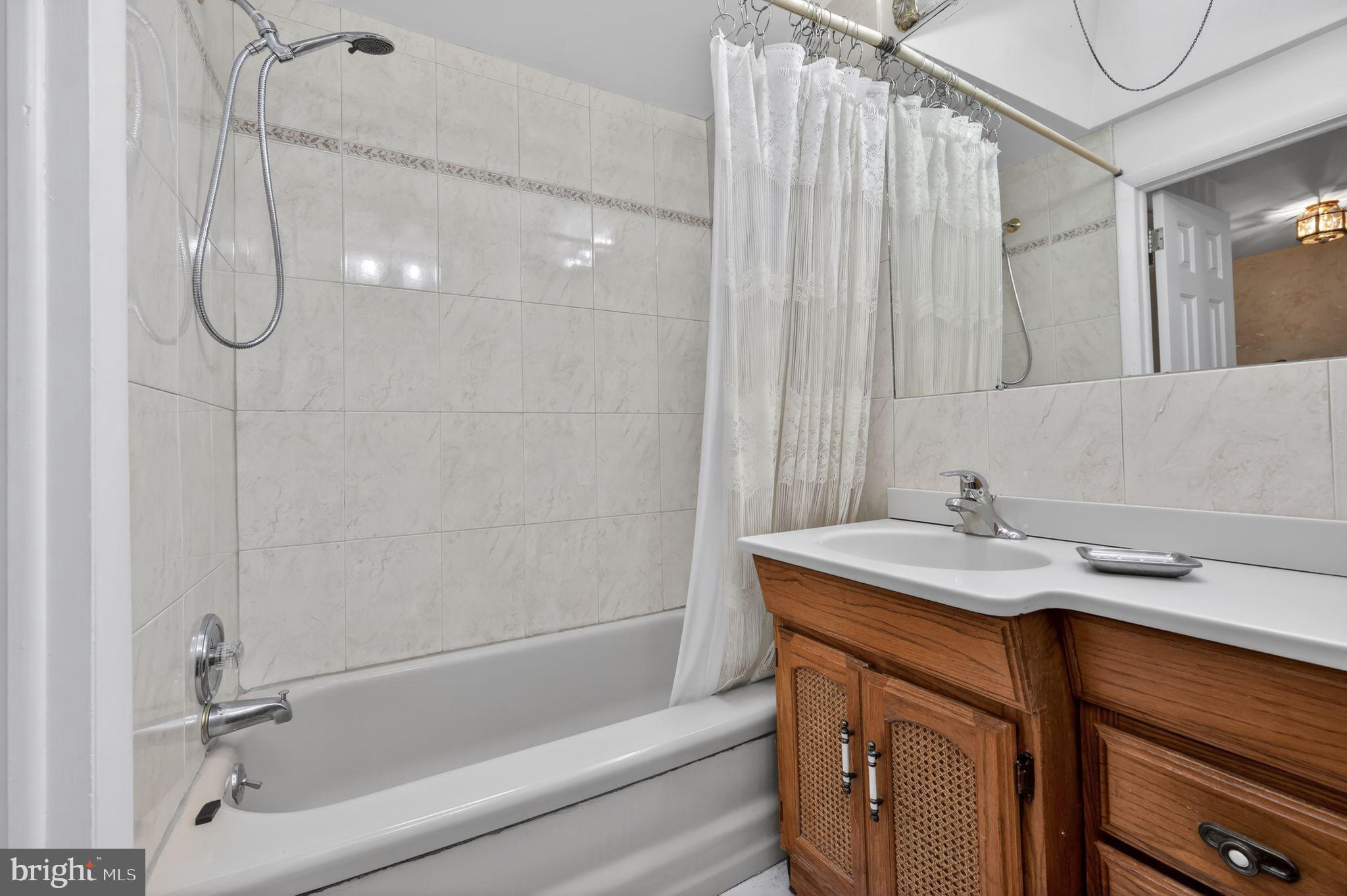 948 Grant Road Folcroft, PA 19032 - Photo 17 of 31 a bathroom with a sink a vanity and a shower