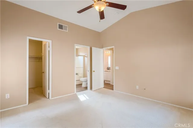 an empty room with chandelier fan