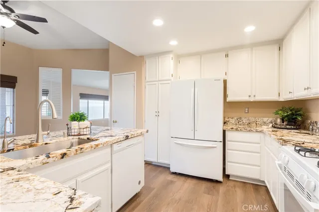 a kitchen with a refrigerator stove and white cabinets