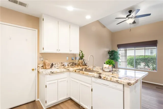 a kitchen with a sink cabinets and window