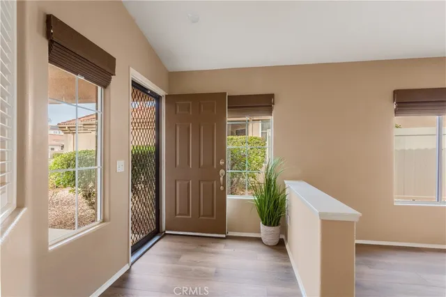 a view of an entryway with wooden floor and windows