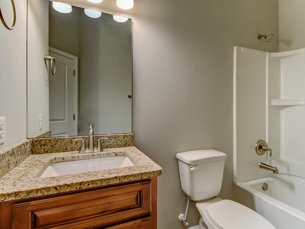 87271 Lents Road Yulee, FL 32097 - Photo 30 of 32 a bathroom with a granite countertop sink toilet and shower