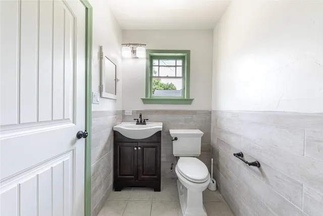 a bathroom with a toilet a sink and mirror