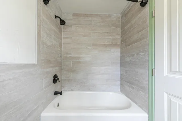 a bath tub sitting next to a white sink
