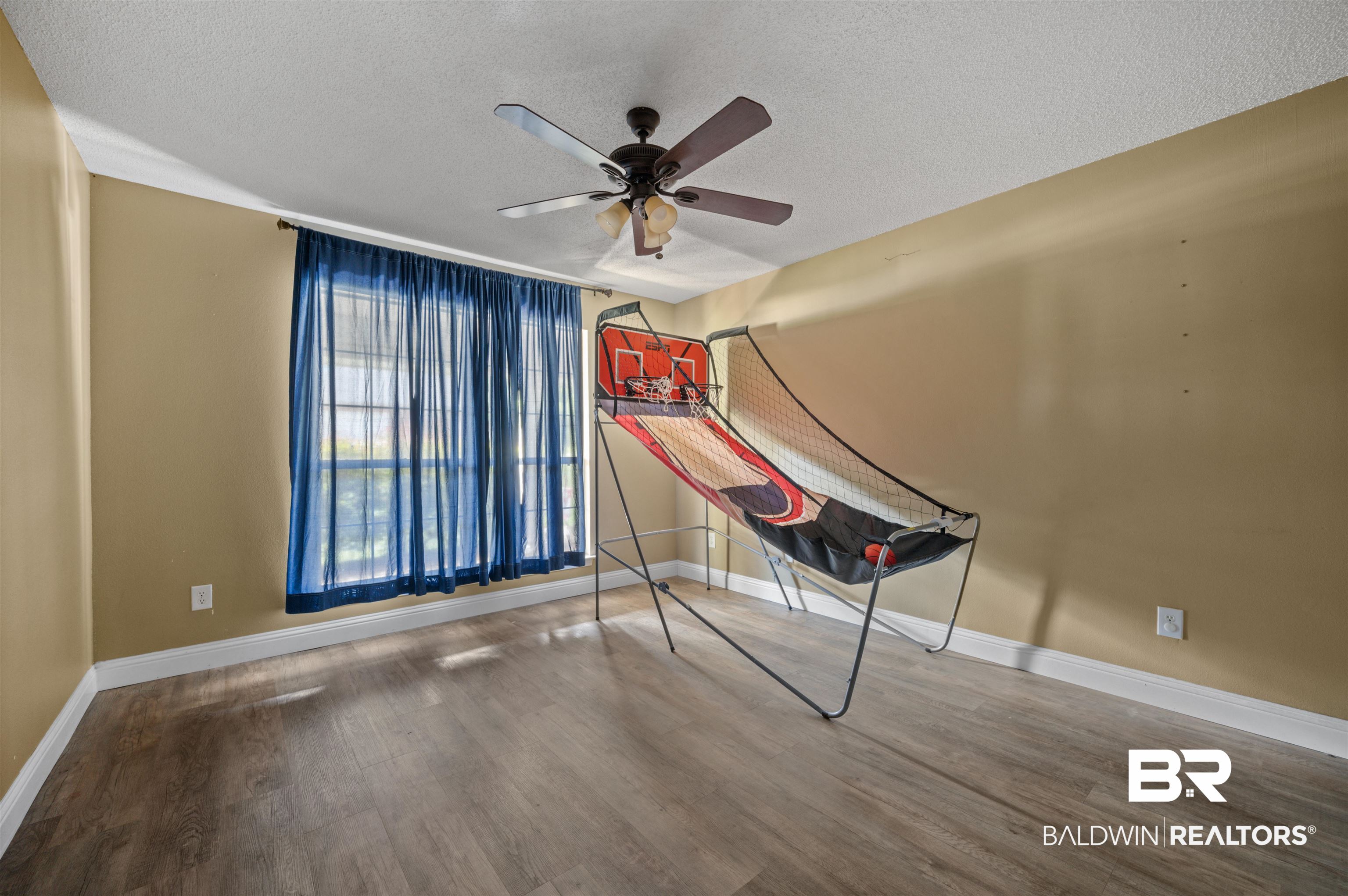 11705 Venice Boulevard Foley, AL 36535 - Photo 18 of 43 Interior space with hardwood / wood-style floors, ceiling fan, and a textured ceiling